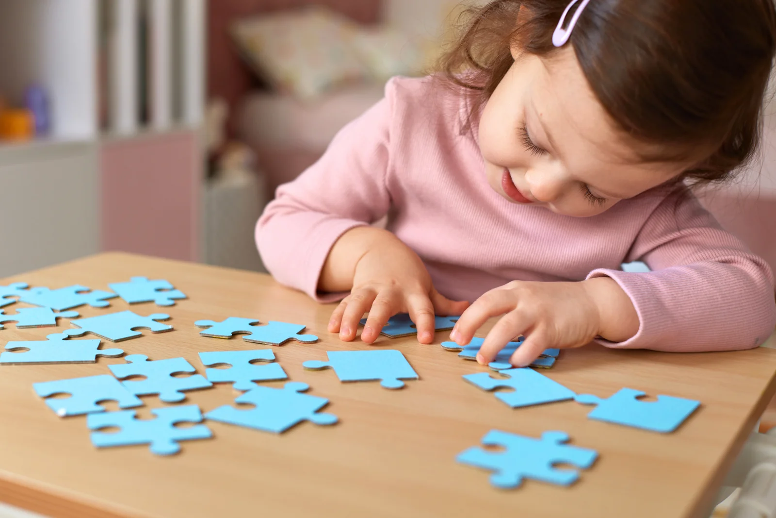 Young girl working a puzzle